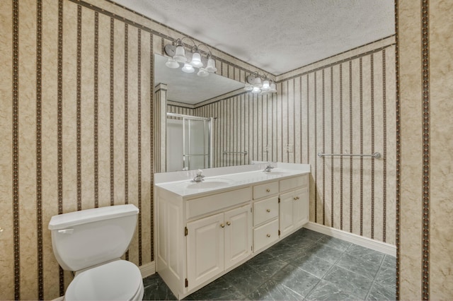 bathroom featuring vanity, a textured ceiling, toilet, and an enclosed shower