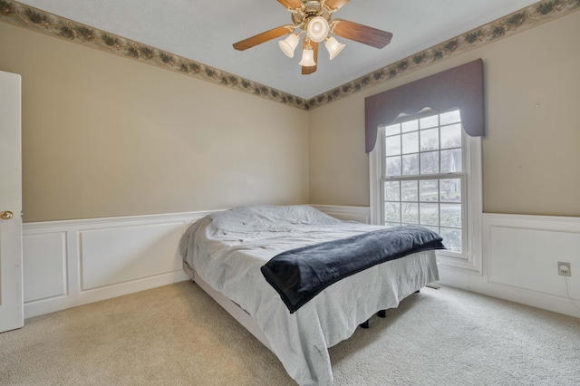 bedroom featuring ceiling fan and light carpet