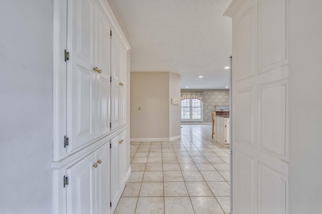 hall featuring light tile patterned floors