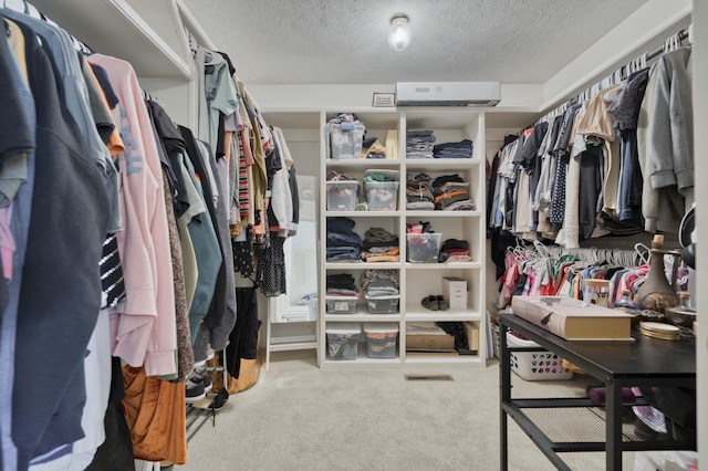 walk in closet featuring carpet