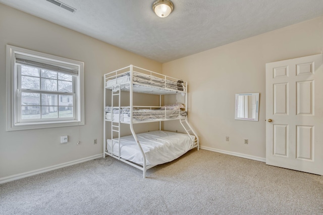 unfurnished bedroom featuring carpet floors and a textured ceiling