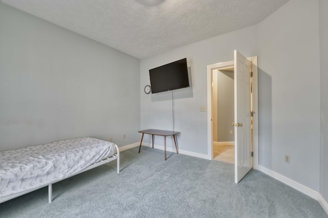 carpeted bedroom featuring a textured ceiling