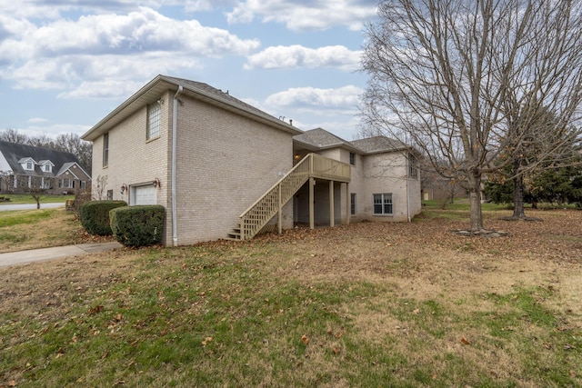 view of property exterior featuring a lawn, a wooden deck, and a garage