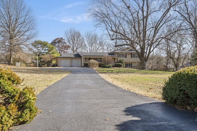 view of front of house featuring a front yard and a garage