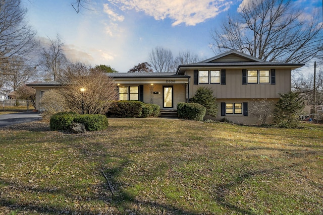 split level home featuring a front lawn