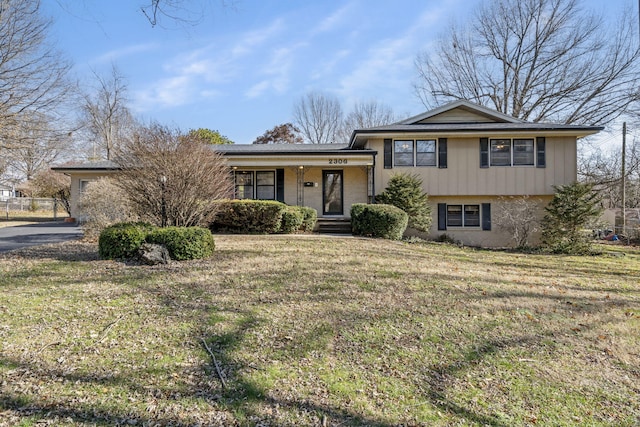 tri-level home with a front lawn