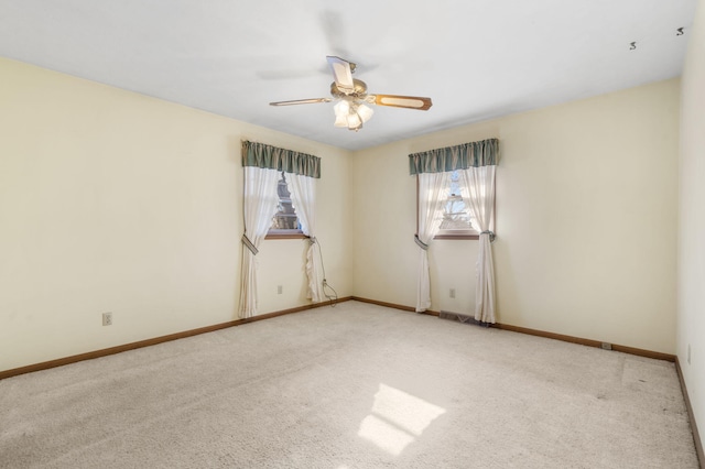 carpeted spare room featuring ceiling fan