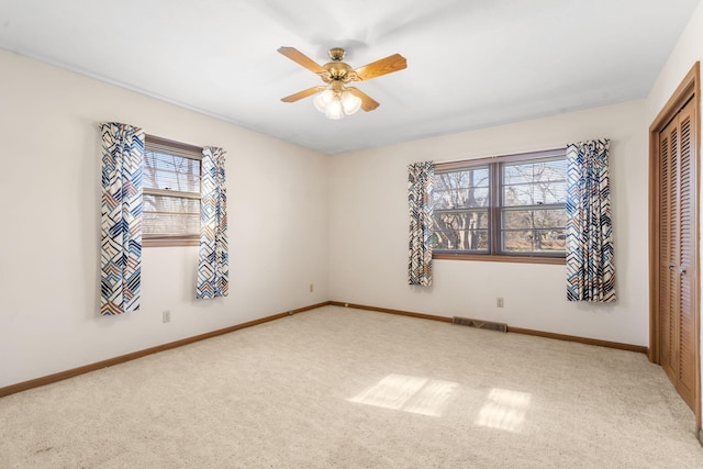 unfurnished bedroom featuring ceiling fan, carpet floors, and a closet