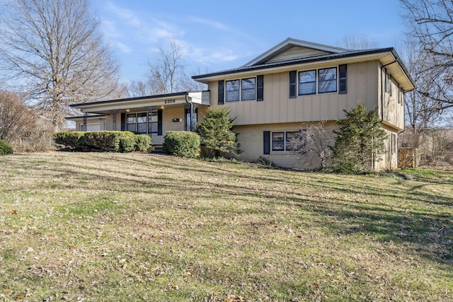 split level home with a front yard and covered porch