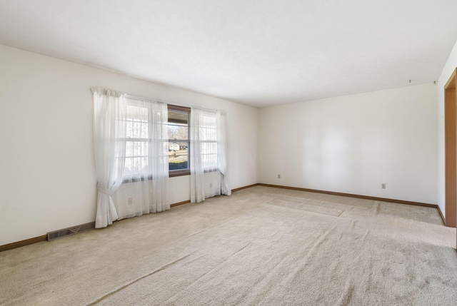 unfurnished room with light colored carpet