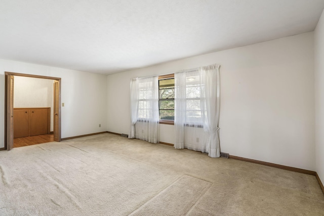 empty room featuring light carpet