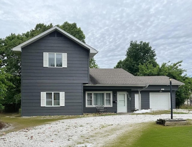 view of front property featuring a garage and a front yard