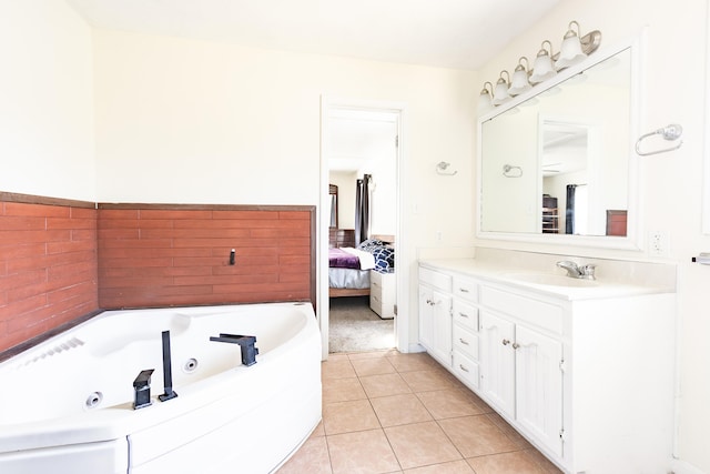 ensuite bathroom with vanity, tile patterned floors, ensuite bath, and a whirlpool tub