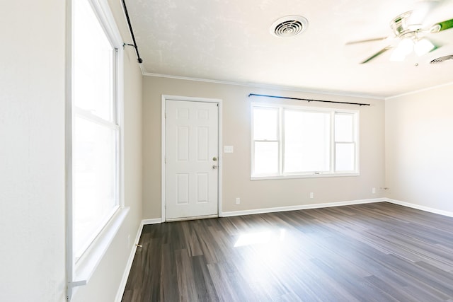 unfurnished room featuring visible vents, baseboards, dark wood-style floors, and a ceiling fan