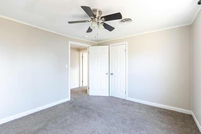 unfurnished bedroom with visible vents, baseboards, carpet, and ornamental molding