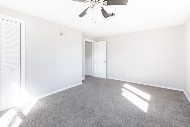 unfurnished bedroom with carpet, baseboards, a closet, and ceiling fan