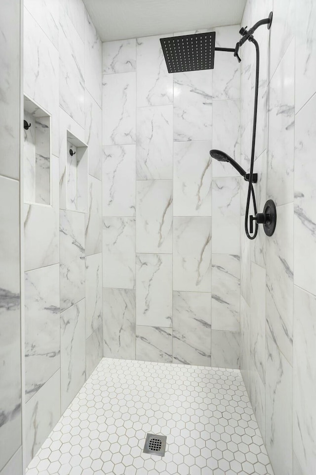 bathroom with a tile shower