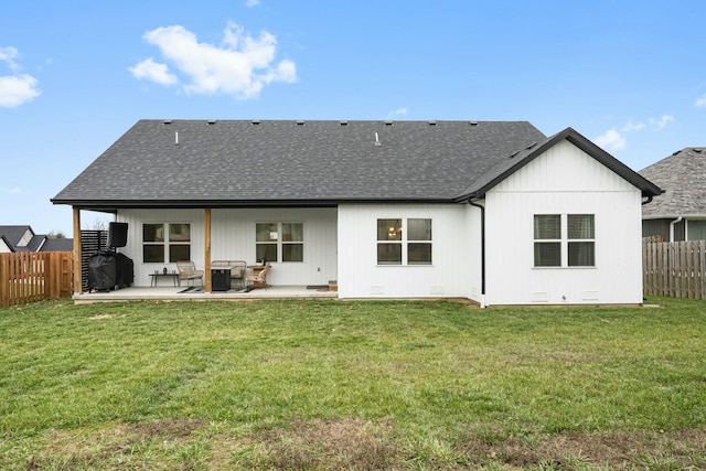 rear view of house with a yard and a patio