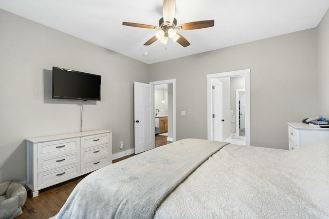 bedroom with dark hardwood / wood-style flooring, ensuite bathroom, ceiling fan, and sink