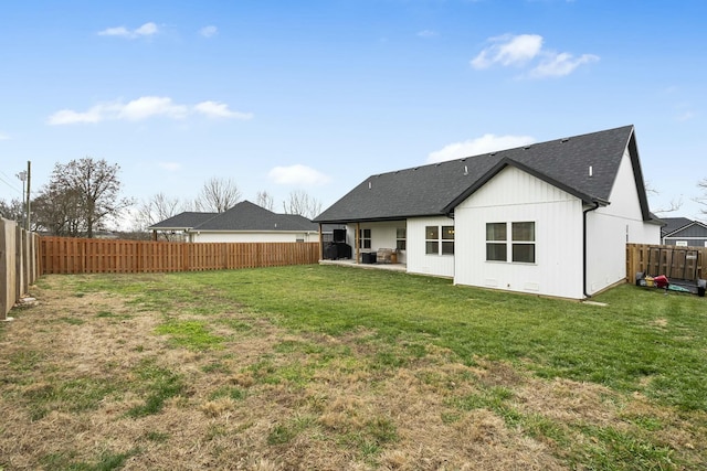 rear view of property featuring a patio area and a yard