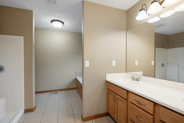 bathroom with tile patterned flooring, vanity, an inviting chandelier, and a bathtub