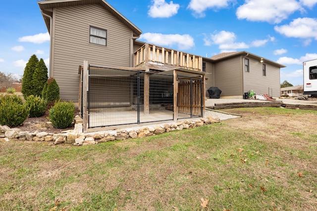 back of house with a deck