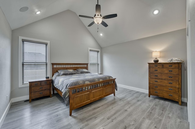 bedroom with ceiling fan, light hardwood / wood-style flooring, and high vaulted ceiling