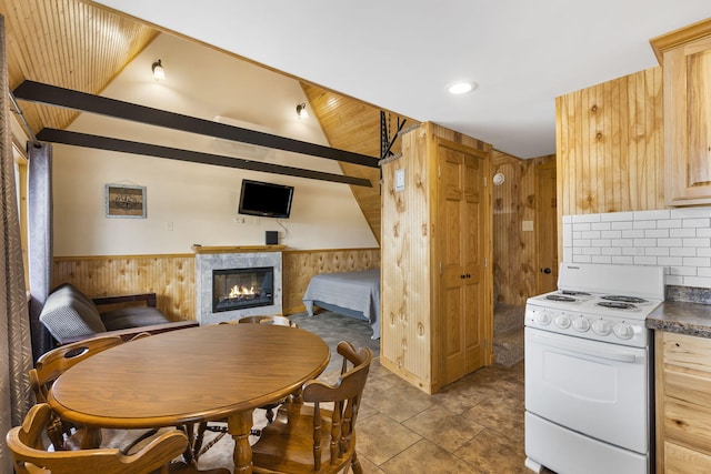 kitchen featuring light brown cabinets, white range oven, vaulted ceiling, wooden walls, and wood ceiling