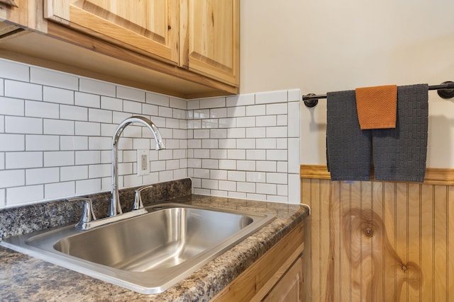 kitchen with light brown cabinets, backsplash, and sink