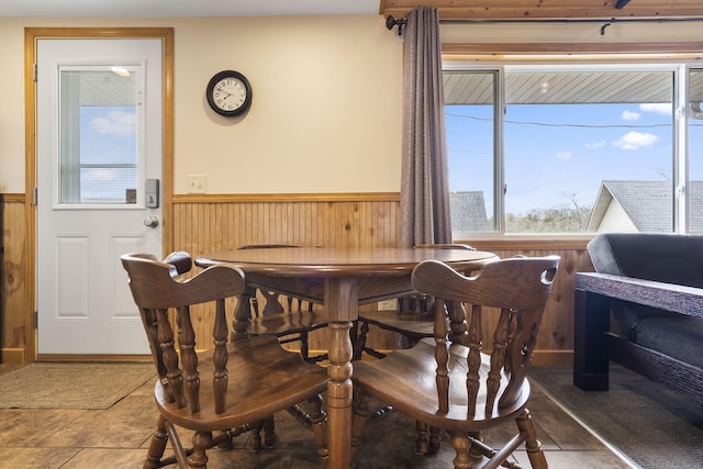 dining room featuring wood walls