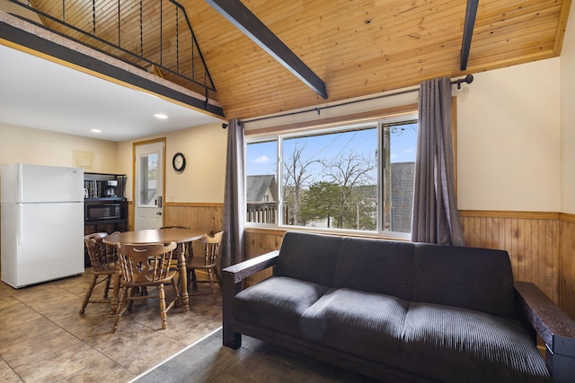 living room featuring lofted ceiling, wood walls, and wood ceiling