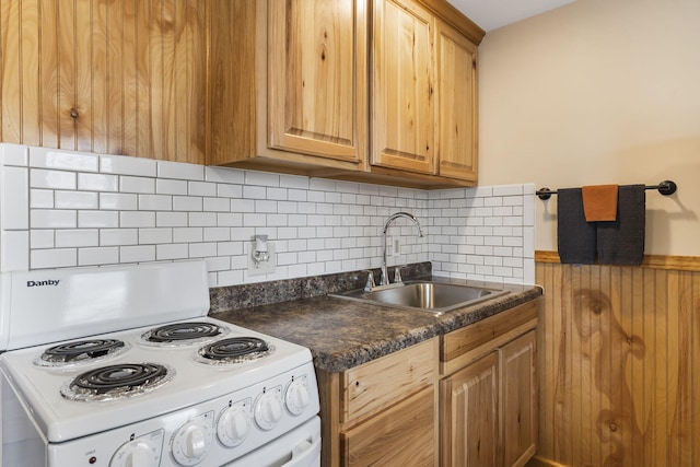 kitchen with backsplash, white electric range, sink, and dark stone counters