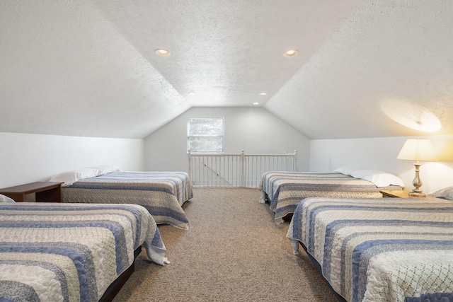 bedroom with dark carpet, lofted ceiling, and a textured ceiling