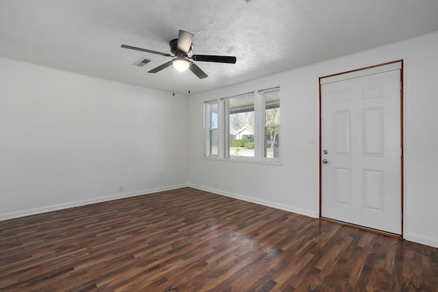 entryway featuring a textured ceiling, dark hardwood / wood-style floors, and ceiling fan