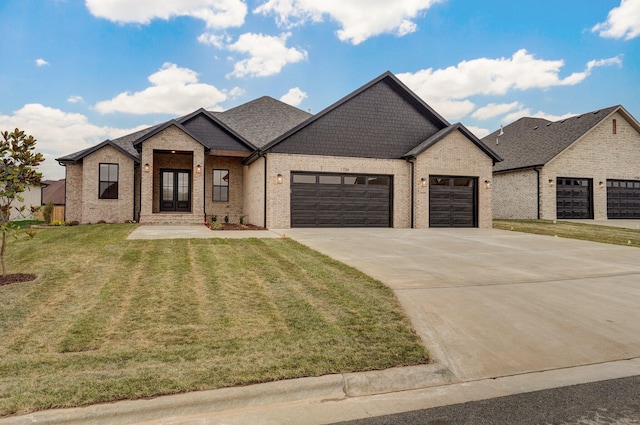 french country style house featuring a front yard and a garage