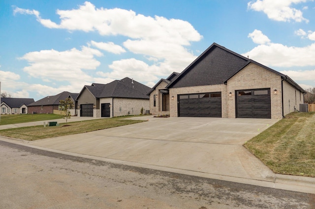 french country style house with central AC, a front yard, and a garage