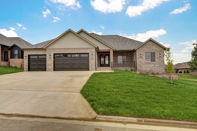 view of front of property with a front lawn and a garage