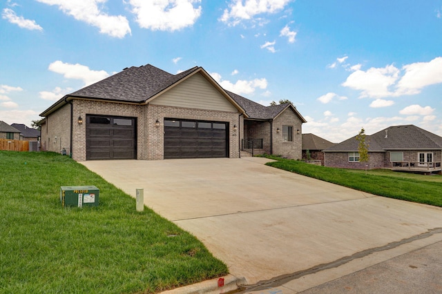 view of front of property with a garage and a front yard