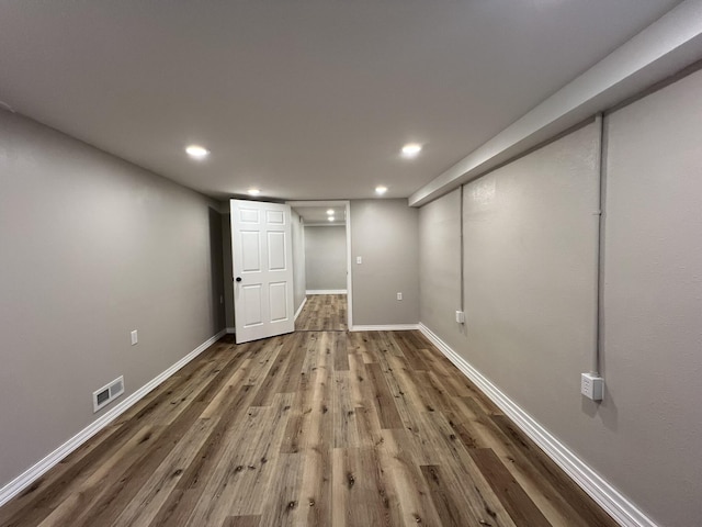 basement with hardwood / wood-style flooring