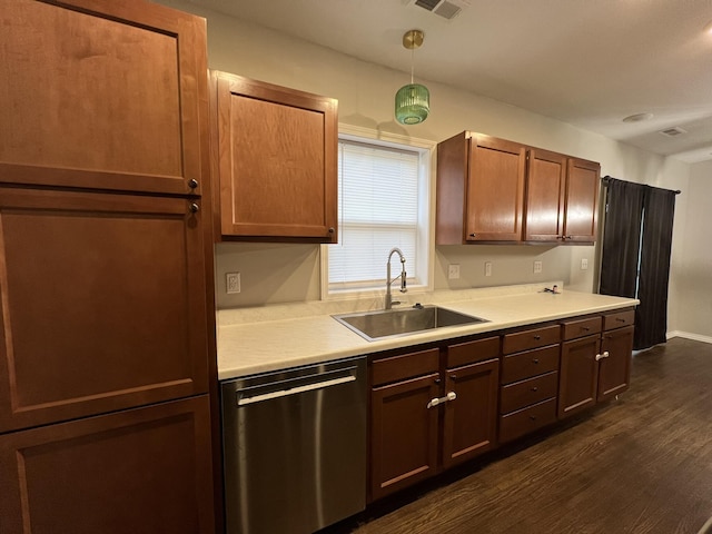 kitchen featuring stainless steel dishwasher, dark hardwood / wood-style flooring, sink, and hanging light fixtures