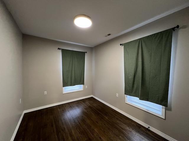 empty room with hardwood / wood-style floors