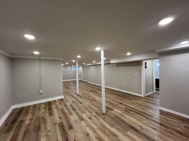 basement with hardwood / wood-style flooring