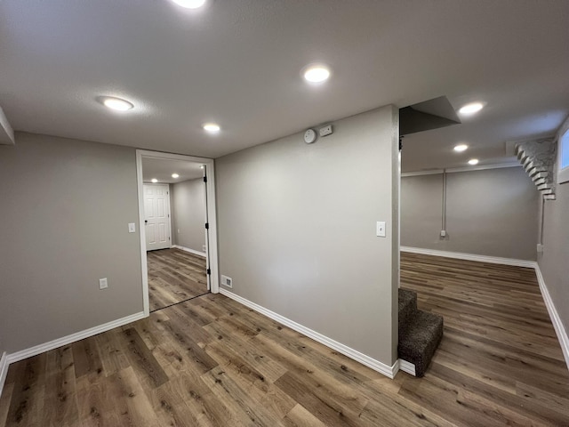 basement with dark hardwood / wood-style flooring