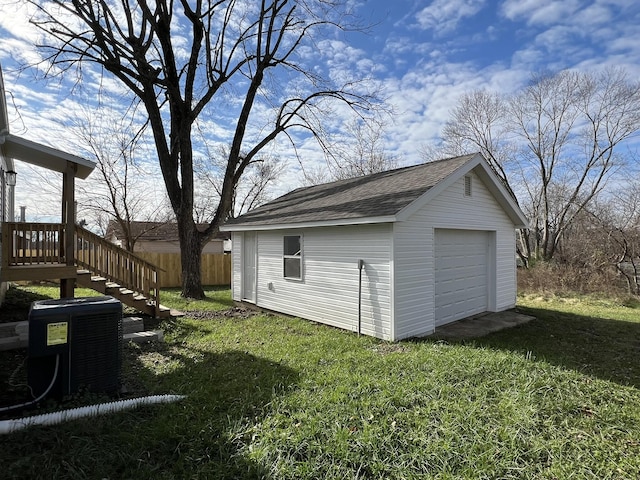 exterior space with central AC, a garage, and an outdoor structure