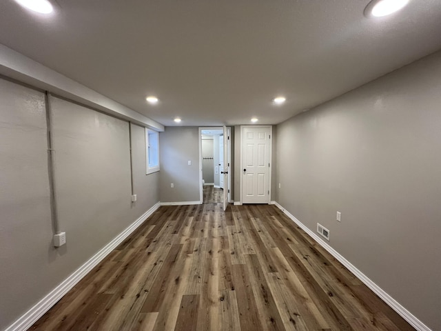 basement featuring dark hardwood / wood-style floors