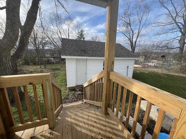 deck with a lawn and a storage shed