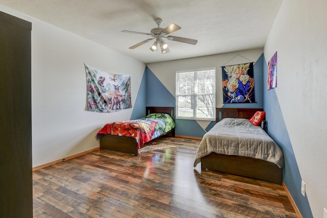 bedroom with dark wood-type flooring and ceiling fan