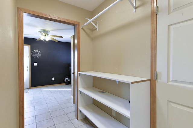 spacious closet featuring ceiling fan and light tile patterned flooring