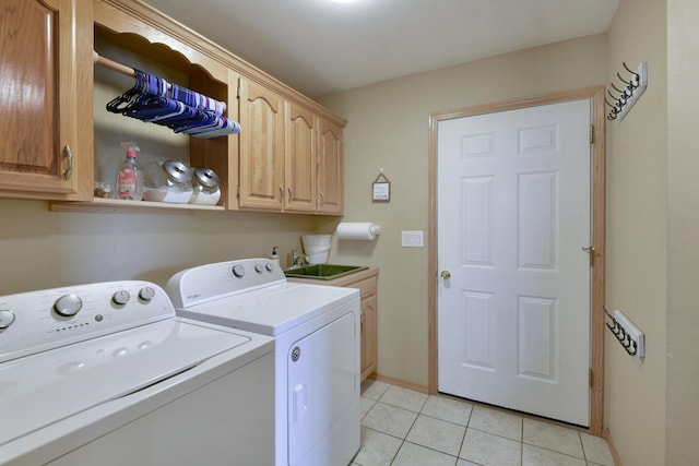 laundry room with cabinets, light tile patterned floors, independent washer and dryer, and sink