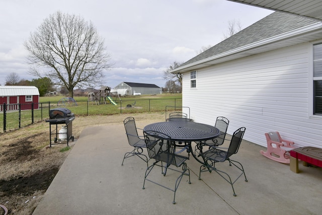 view of patio / terrace featuring a playground and area for grilling